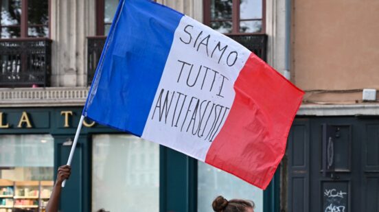 A French flag bearing the words SIAMO TUTTI ANTIFASCISTI